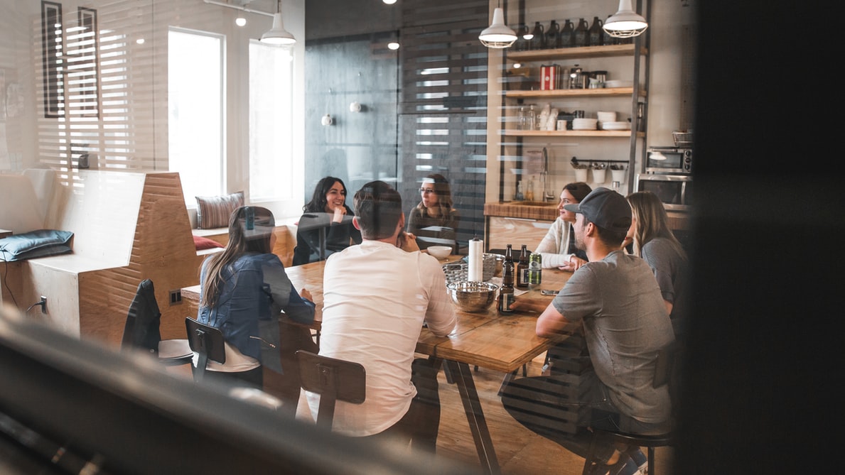Friends gather around the table to discuss ideas