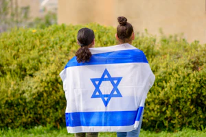 2 young girls stand in peace and respect for the nation of Israel 